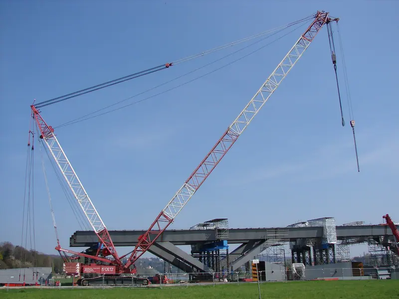 Two crawler cranes working together on a bridge job